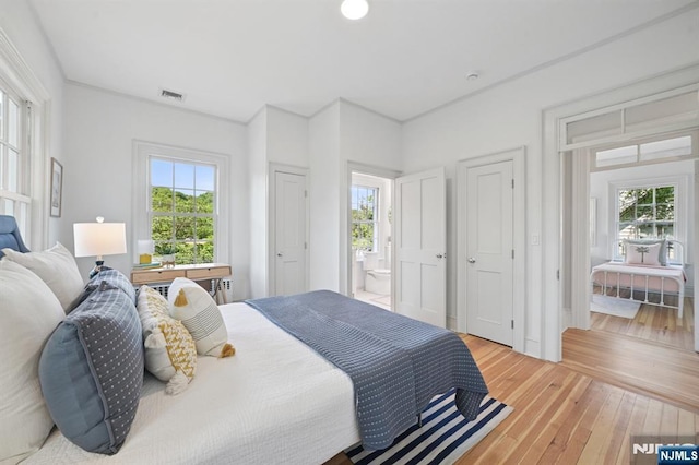 249 Valley Rd, Montclair, NJ 07042 - bedroom featuring multiple windows, light wood-type flooring, and ensuite bath