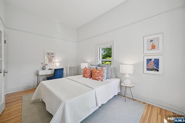 249 Valley Rd, Montclair, NJ 07042 - bedroom featuring radiator heating unit, light wood-type flooring, and baseboards