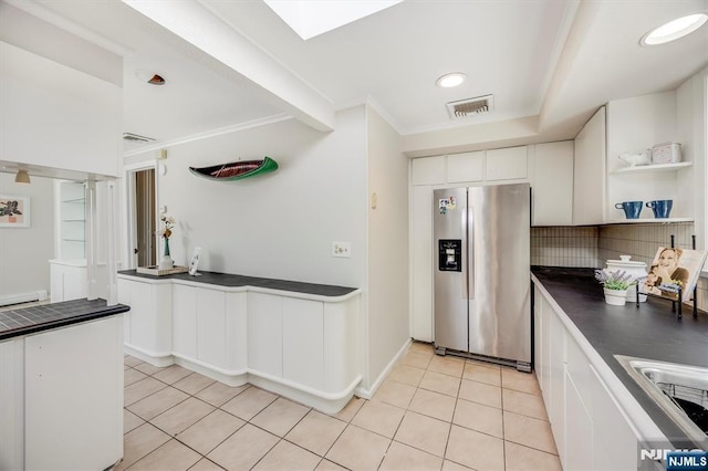 60 Leach Dr, Bloomingdale, NJ 07403 - kitchen with stainless steel fridge with ice dispenser, light tile patterned floors, white cabinetry, open shelves, and crown molding