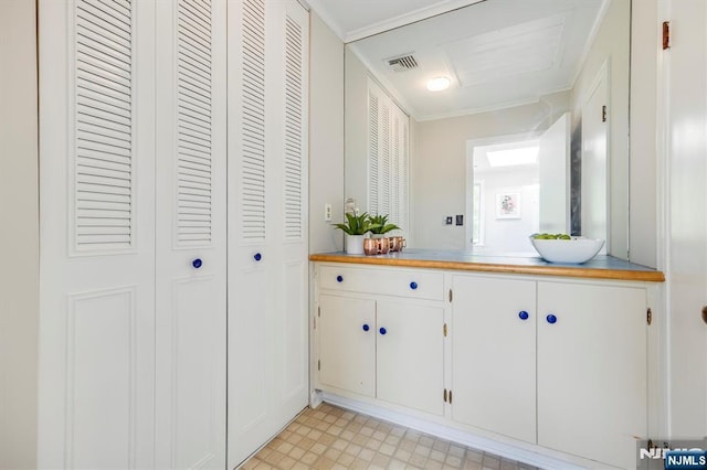 60 Leach Dr, Bloomingdale, NJ 07403 - bathroom featuring a closet, vanity, crown molding, and tile patterned floors