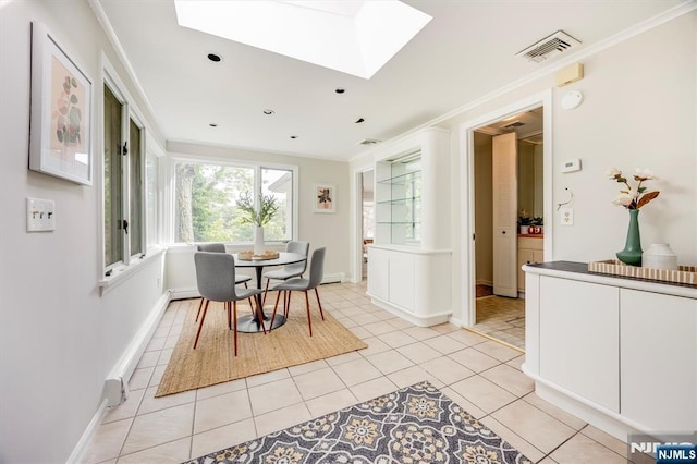 60 Leach Dr, Bloomingdale, NJ 07403 - dining area with a skylight, ornamental molding, light tile patterned floors, baseboards, and a baseboard heating unit