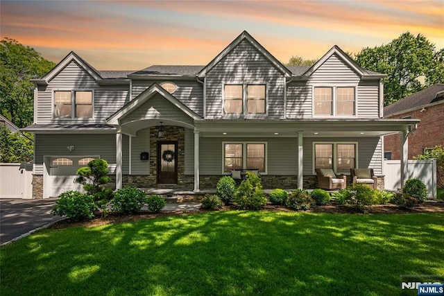 61 Ferndale Rd, Paramus, NJ 07652 - view of front of home featuring an attached garage, covered porch, driveway, and stone siding