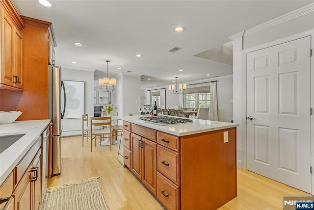 61 Ferndale Rd, Paramus, NJ 07652 - kitchen featuring a chandelier, light wood-style floors, brown cabinetry, a kitchen island, and recessed lighting