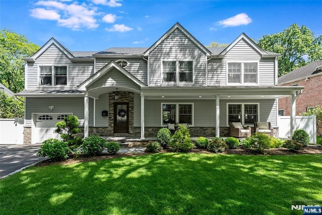 61 Ferndale Rd, Paramus, NJ 07652 - view of front of home with a porch, an attached garage, stone siding, and asphalt driveway