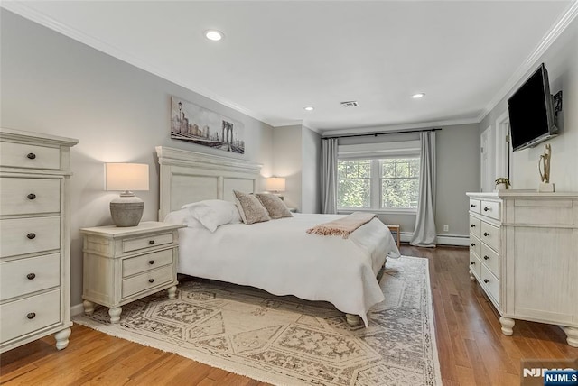61 Ferndale Rd, Paramus, NJ 07652 - bedroom with ornamental molding, wood finished floors, recessed lighting, a baseboard heating unit, and baseboards