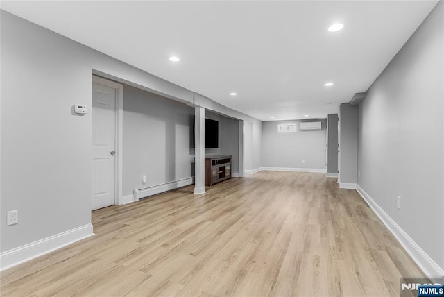 61 Ferndale Rd, Paramus, NJ 07652 - finished below grade area featuring a wall unit AC, light wood finished floors, recessed lighting, baseboards, and a baseboard heating unit