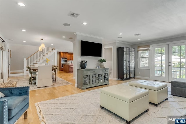 61 Ferndale Rd, Paramus, NJ 07652 - living area with ornamental molding, stairway, recessed lighting, french doors, and light wood-style flooring