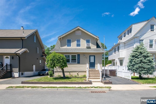65 Byrne St, Hackensack, NJ 07601 - view of front facade featuring roof with shingles, asphalt driveway, and entry steps
