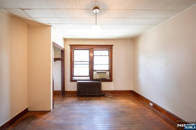 65 Byrne St, Hackensack, NJ 07601 - spare room featuring hardwood / wood-style floors, cooling unit, radiator, and baseboards