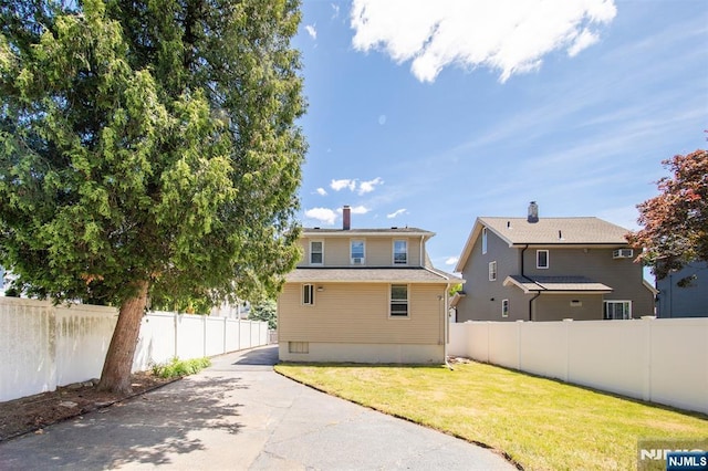 65 Byrne St, Hackensack, NJ 07601 - rear view of house featuring concrete driveway and a chimney