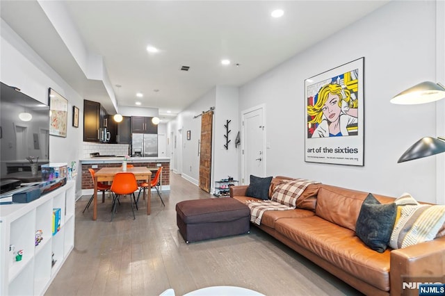 172 S St Unit 2A, Jersey City, NJ 07307 - living area featuring light wood-style floors, recessed lighting, and a barn door