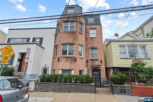 172 S St Unit 2A, Jersey City, NJ 07307 - townhome / multi-family property featuring brick siding and a fenced front yard