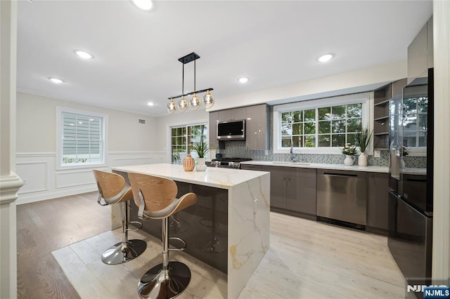 16 Coles Ct, River Edge, NJ 07661 - kitchen with stainless steel dishwasher, a sink, stove, a kitchen island, and modern cabinets