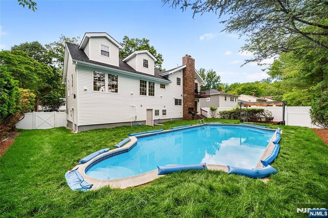 16 Coles Ct, River Edge, NJ 07661 - back of property featuring a chimney and a gate