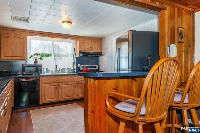 16 Dalewood Rd, Wayne, NJ 07470 - kitchen with stainless steel appliances, under cabinet range hood, a breakfast bar area, dark countertops, and a sink
