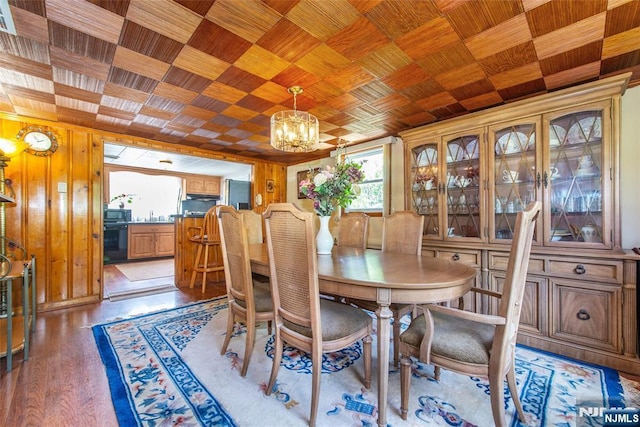 16 Dalewood Rd, Wayne, NJ 07470 - dining area featuring healthy amount of natural light, a chandelier, wooden walls, light wood-style flooring, and wood ceiling