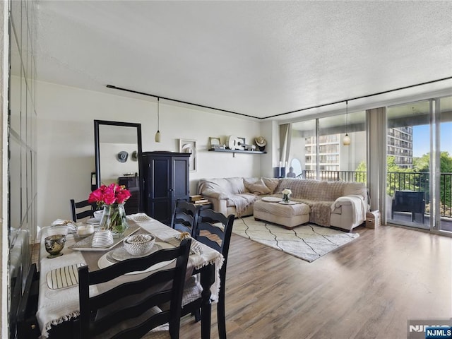 5 Horizon Rd Unit 306, Fort Lee, NJ 07024 - dining room featuring wood finished floors, a textured ceiling, and floor to ceiling windows