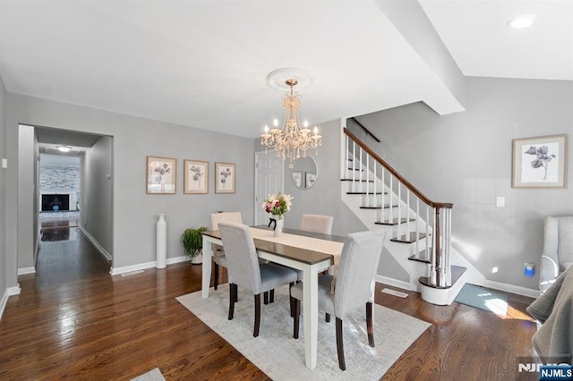 97 Avenue Ave, Lodi, NJ 07644 - dining room featuring stairs, a chandelier, dark wood finished floors, and baseboards