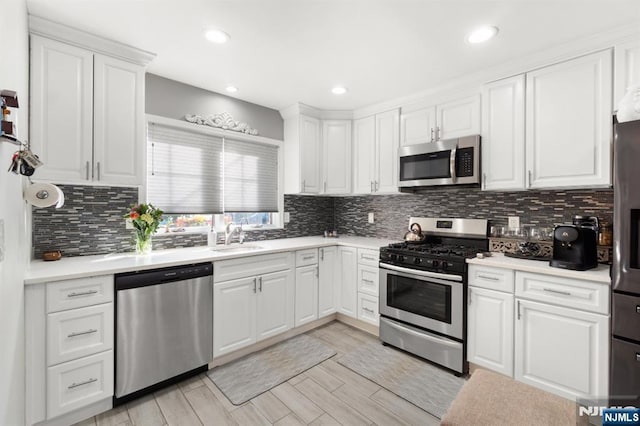 97 Avenue Ave, Lodi, NJ 07644 - kitchen with stainless steel appliances, white cabinets, light countertops, and recessed lighting