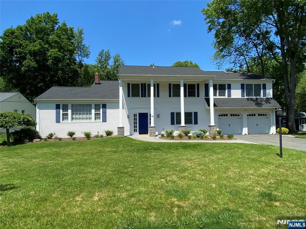 30 Normandy Dr, Par-Troy Hills Twp, NJ 07054 - neoclassical home with driveway, a garage, and a front lawn