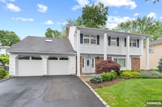 4 Kimberly Way, River Edge, NJ 07661 - view of front of house with a garage, asphalt driveway, brick siding, a chimney, and a front yard