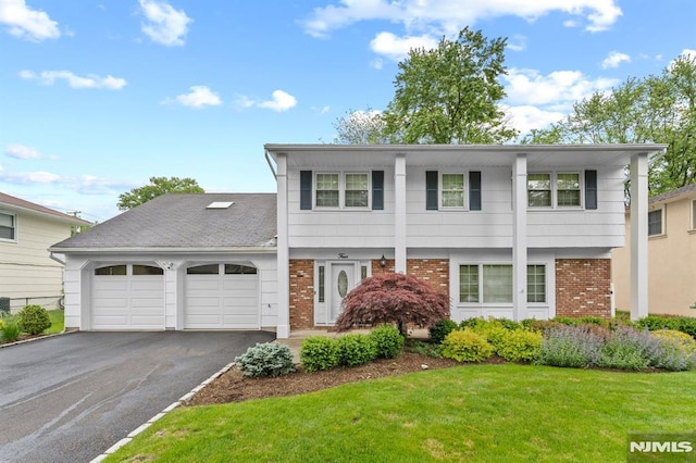 4 Kimberly Way, River Edge, NJ 07661 - view of front facade with an attached garage, asphalt driveway, brick siding, and a front yard