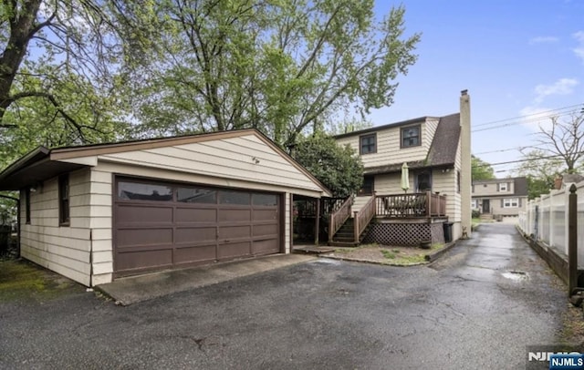 202 Linden Ave, Verona, NJ 07044 - view of front of property with an outdoor structure, a garage, a chimney, and a deck