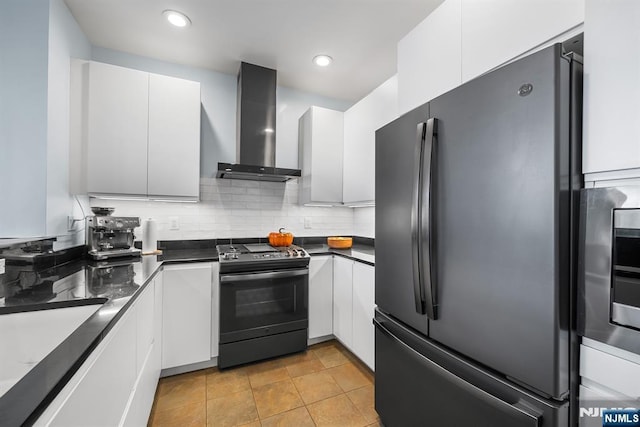 41 Lydia Dr Unit 41, West New York, NJ 07093 - kitchen with freestanding refrigerator, black gas stove, wall chimney exhaust hood, dark countertops, and recessed lighting