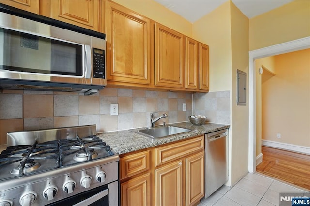 50 Reservoir Ave Unit 201, Jersey City, NJ 07307 - kitchen featuring appliances with stainless steel finishes, a sink, light tile patterned floors, decorative backsplash, and electric panel
