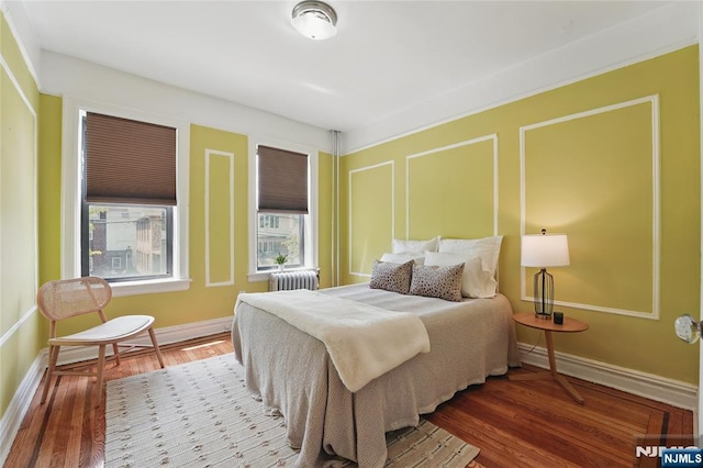 50 Reservoir Ave Unit 201, Jersey City, NJ 07307 - bedroom featuring radiator heating unit, wood finished floors, and baseboards