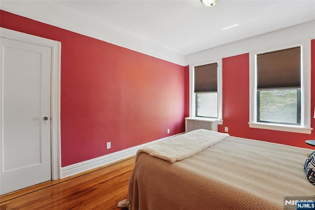 50 Reservoir Ave Unit 201, Jersey City, NJ 07307 - bedroom with wood finished floors and baseboards