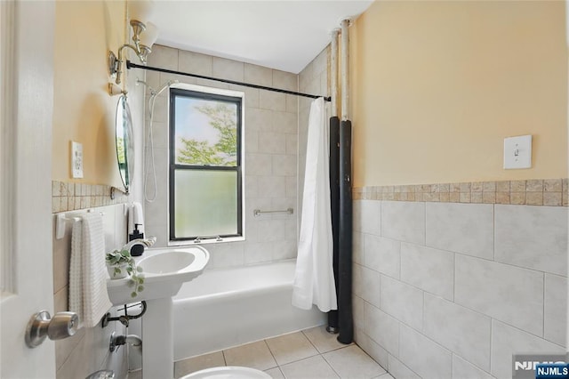 50 Reservoir Ave Unit 201, Jersey City, NJ 07307 - bathroom featuring tile walls, tile patterned flooring, shower / bath combination with curtain, and wainscoting