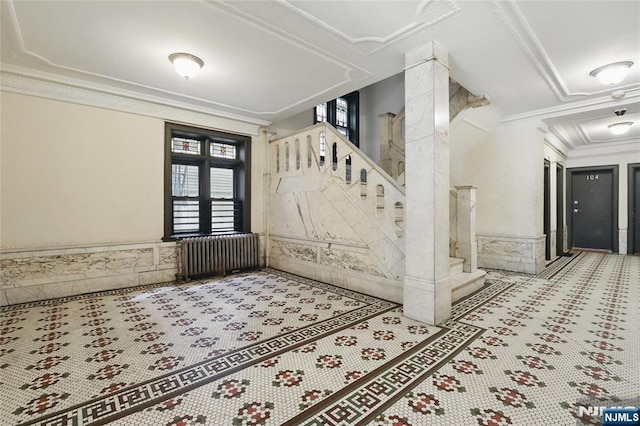 50 Reservoir Ave Unit 201, Jersey City, NJ 07307 - tiled foyer featuring ornamental molding, stairway, radiator, and wainscoting