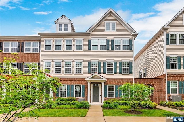 83 Landmark Ln, Fair Lawn, NJ 07410 - view of property featuring brick siding and central AC unit