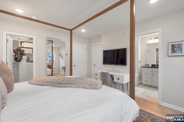 83 Landmark Ln, Fair Lawn, NJ 07410 - bedroom with light wood-type flooring, a spacious closet, a closet, recessed lighting, and connected bathroom
