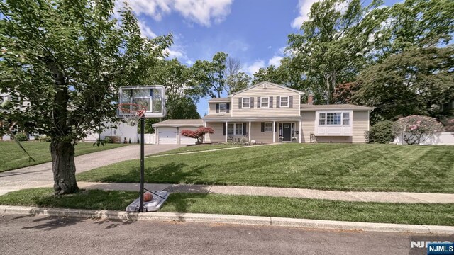 27 Bristol Pl, Wayne, NJ 07470 - split level home with driveway, a front yard, a garage, and covered porch