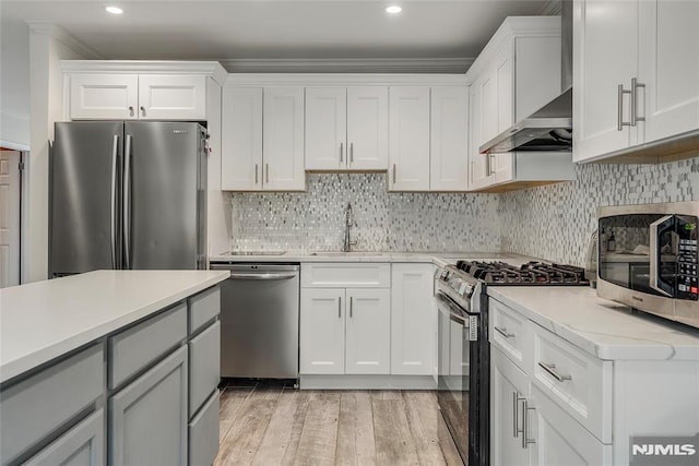 53 Princeton Pl, Wayne, NJ 07470 - kitchen featuring appliances with stainless steel finishes, a sink, wall chimney exhaust hood, light countertops, and recessed lighting