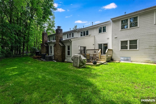 53 Princeton Pl, Wayne, NJ 07470 - rear view of house featuring a chimney, a lawn, and a deck