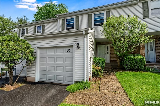 53 Princeton Pl, Wayne, NJ 07470 - view of front of property with a garage, brick siding, and asphalt driveway