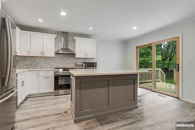 53 Princeton Pl, Wayne, NJ 07470 - kitchen featuring wall chimney range hood, stainless steel appliances, crown molding, backsplash, and light countertops