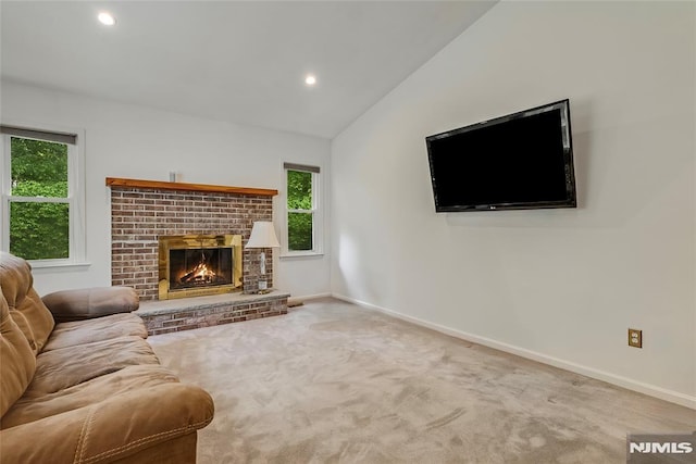 53 Princeton Pl, Wayne, NJ 07470 - living room featuring healthy amount of natural light, a brick fireplace, carpet, baseboards, and vaulted ceiling