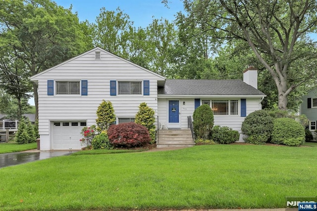 259 Burnside Pl, Ridgewood, NJ 07450 - split level home with a chimney, a garage, driveway, and a front yard