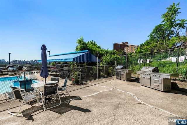 9060 Palisade Unit 612, North Bergen, NJ 07047 - view of patio / terrace featuring grilling area and a community pool