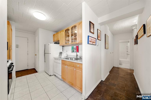 9060 Palisade Unit 612, North Bergen, NJ 07047 - kitchen featuring a sink, white appliances, glass insert cabinets, light countertops, and baseboards