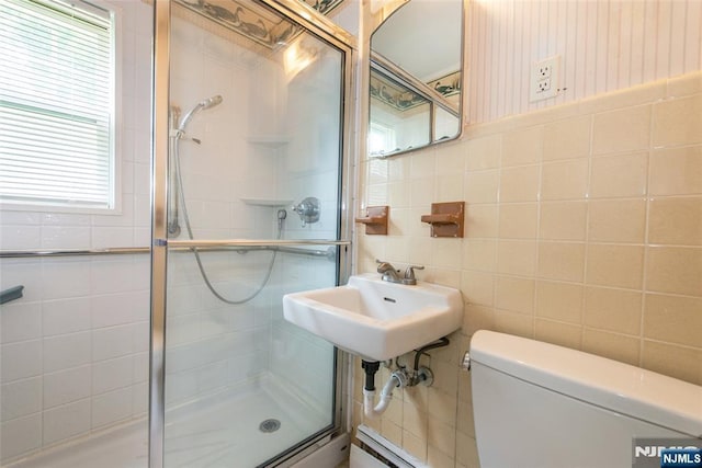 57 Burnside, Wanaque, NJ 07420 - bathroom featuring tile walls, a shower stall, toilet, and a sink