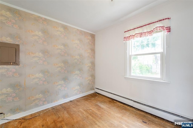 57 Burnside, Wanaque, NJ 07420 - spare room featuring a baseboard radiator, wood finished floors, baseboards, ornamental molding, and electric panel