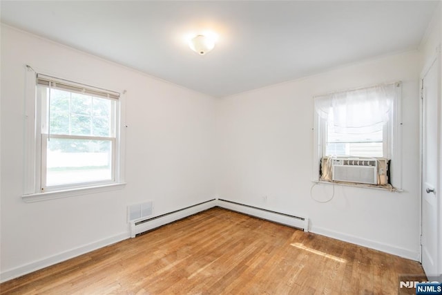 57 Burnside, Wanaque, NJ 07420 - spare room featuring cooling unit, light wood-style flooring, baseboards, and a baseboard heating unit