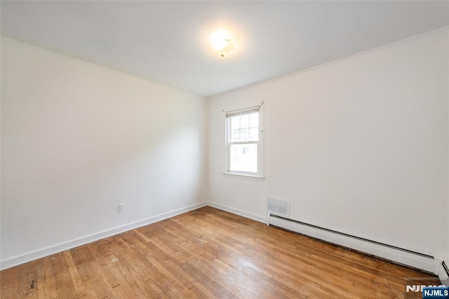 57 Burnside, Wanaque, NJ 07420 - empty room featuring a baseboard heating unit, light wood-style floors, and baseboards