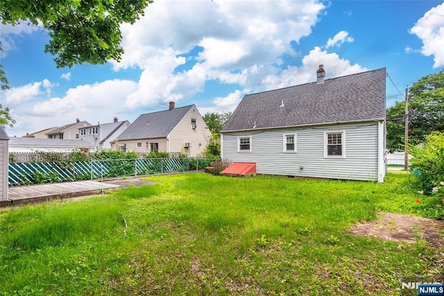 57 Burnside, Wanaque, NJ 07420 - back of property featuring a chimney and roof with shingles