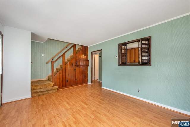 57 Burnside, Wanaque, NJ 07420 - unfurnished living room featuring crown molding, wood finished floors, baseboards, wallpapered walls, and stairs